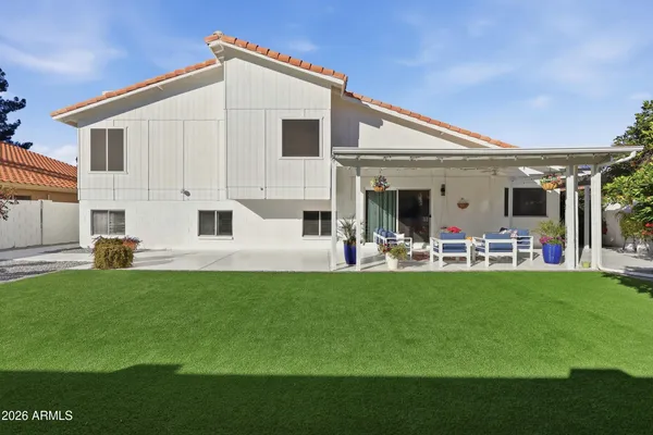 a view of a patio with table and chairs under an umbrella