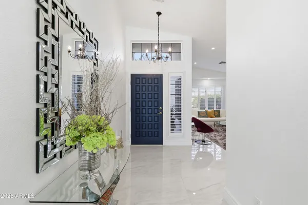 a kitchen with stainless steel appliances kitchen island granite countertop a refrigerator a stove a kitchen island a dining table and chairs with wooden floor