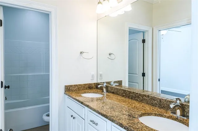 an empty room with wooden floor chandelier and window