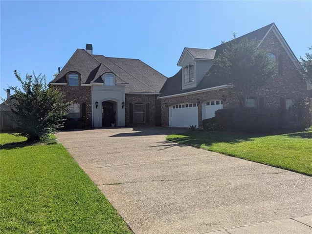 a living room with furniture a fireplace and a chandelier