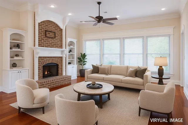 a view of an empty room with wooden floor fireplace and a window