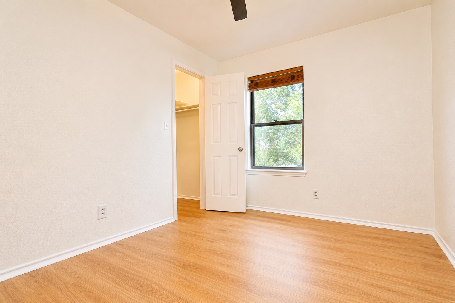 8807 Springmail Circle, Unit A Austin, TX 78729 - Photo 29 of 40 A well-lit bedroom features durable laminate flooring and a convenient walk-in closet.