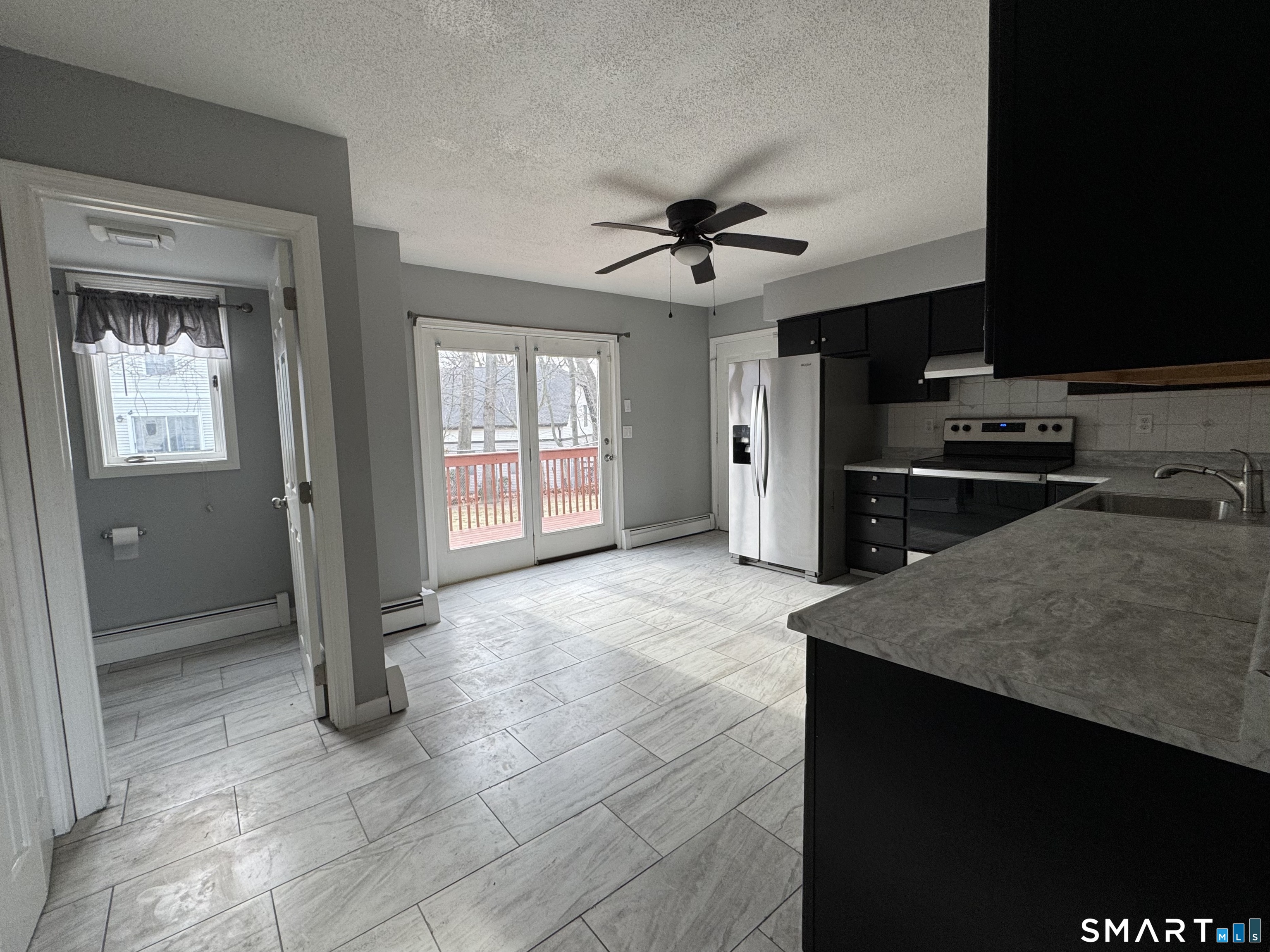 27 Katie Lane Waterbury, CT 06708 - Photo 3 of 14 a view of a kitchen with a stove cabinets and a refrigerator
