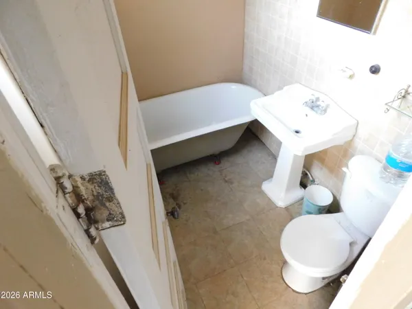 a bathroom with a sink toilet and mirror