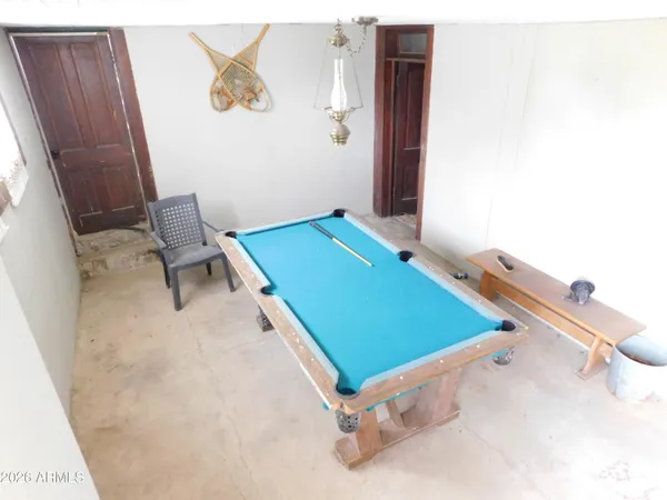 a backyard of a house with large trees and covered by side of it