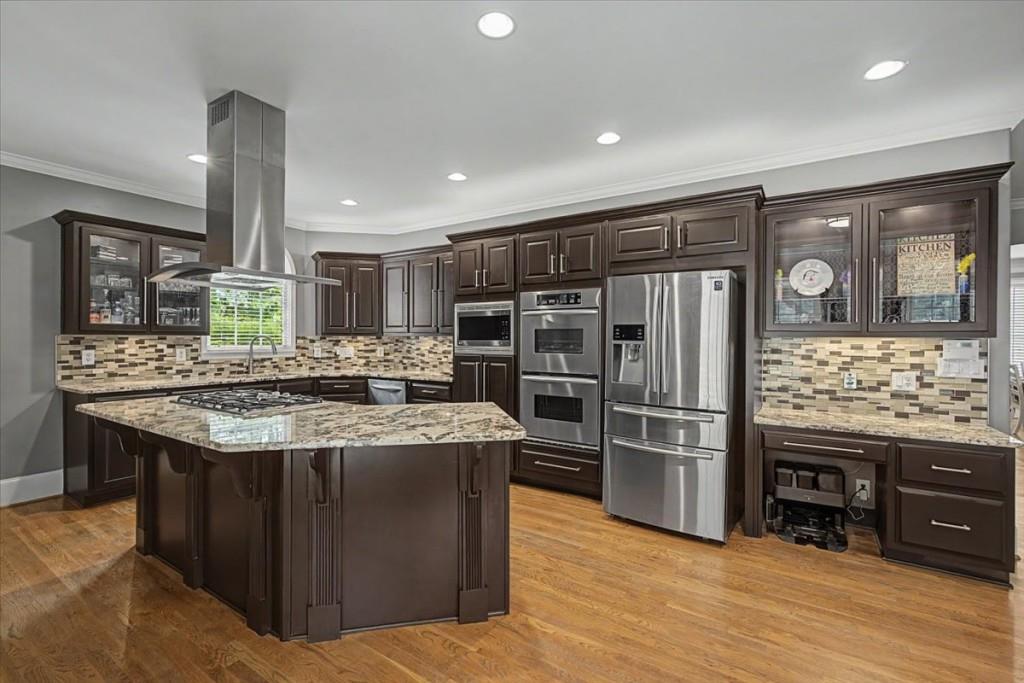 122 Ridge View Drive Ball Ground, GA 30107 - Photo 27 of 84 a kitchen with stainless steel appliances granite countertop a table and chairs