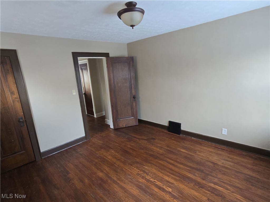 2048 Rossmoor Road Cleveland Heights, OH 44118 - Photo 22 of 29 Unfurnished bedroom featuring baseboards and dark wood finished floors