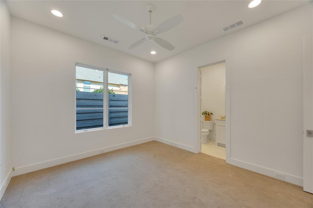 5552 Longview Street Dallas, TX 75206 - Photo 35 of 36 This bedroom is on the first floor toward the back of the home, so it's private and is spacious. Private bath and walk-in closet.