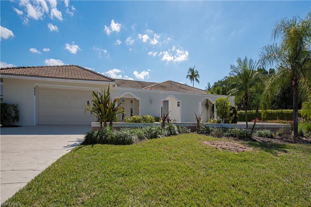 502 Whispering Pine Lane Naples, FL 34103 - Photo 11 of 11 a front view of a house with garden