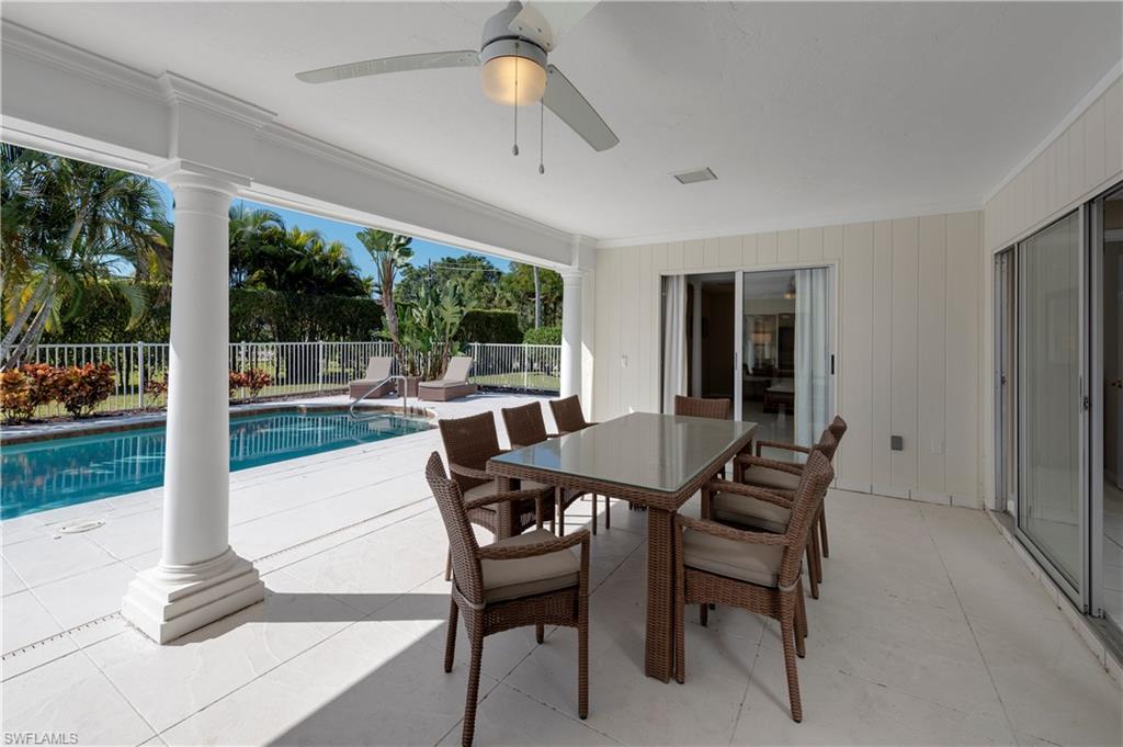 502 Whispering Pine Lane Naples, FL 34103 - Photo 3 of 11 a dining room with furniture and a floor to ceiling window