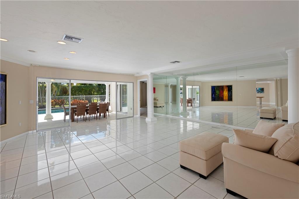 502 Whispering Pine Lane Naples, FL 34103 - Photo 5 of 11 a living room with furniture and a table