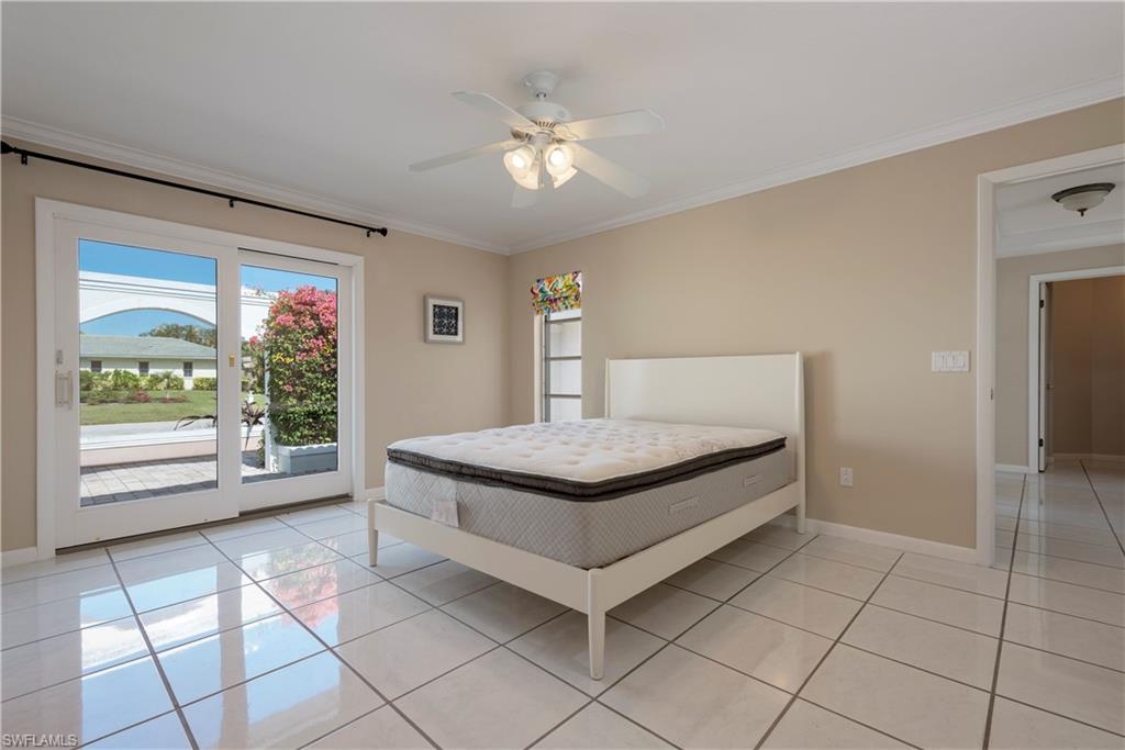 502 Whispering Pine Lane Naples, FL 34103 - Photo 10 of 11 a living room with granite countertop furniture and a flat screen tv