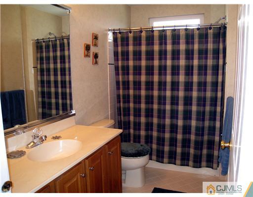 33 Brownstone Road East Windsor, NJ 08520 - Photo 16 of 20 a bathroom with a sink toilet and shower