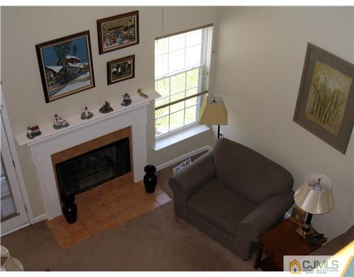 33 Brownstone Road East Windsor, NJ 08520 - Photo 7 of 20 a living room with furniture and a fireplace