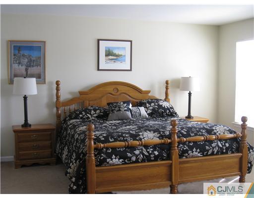 33 Brownstone Road East Windsor, NJ 08520 - Photo 9 of 20 a bedroom with a bed and a table