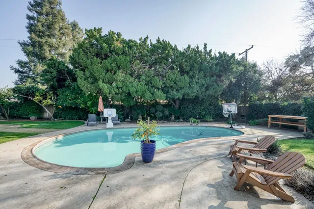 a view of a house with backyard porch and sitting area