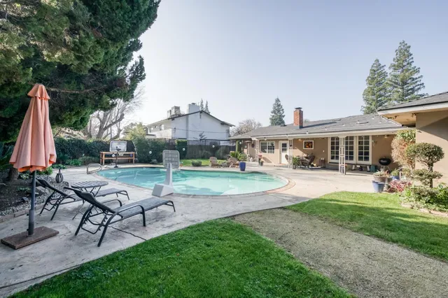 a kitchen with stainless steel appliances kitchen island granite countertop a sink stove and refrigerator