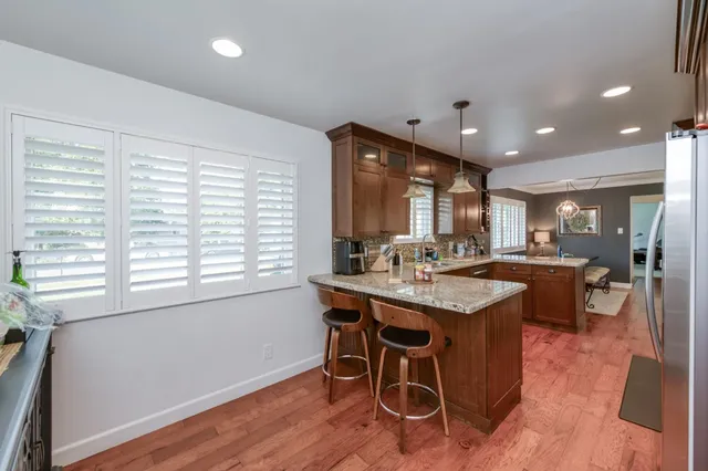 a living room with furniture a window and a clock
