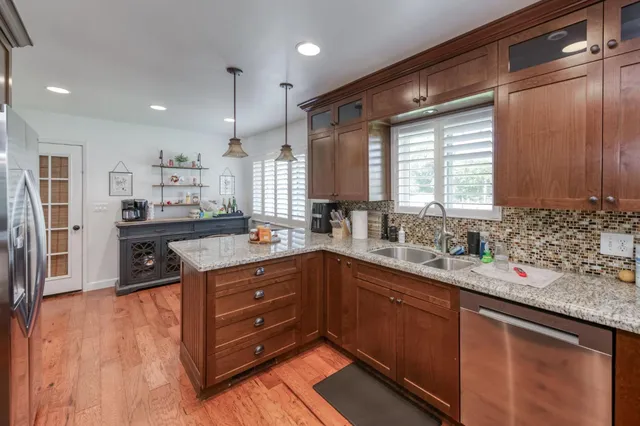 a view of a dining room with furniture wooden floor and chandelier