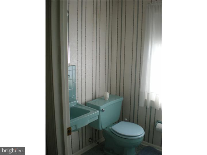 4 Ramsgate Road Cherry Hill, NJ 08003 - Photo 14 of 24 a white toilet sitting next to a bathroom sink