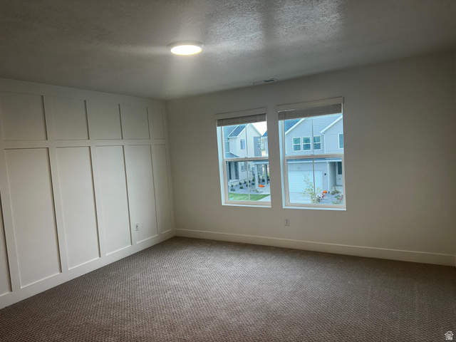 61 South Lunar Way Mapleton, UT 84664 - Photo 6 of 15 Carpeted empty room featuring a textured ceiling and baseboards
