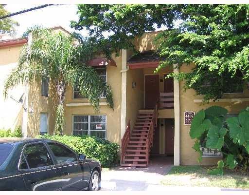4403 Treehouse Lane, Unit H Tamarac, FL 33319 - Photo 1 of 26 a front view of a house with garden