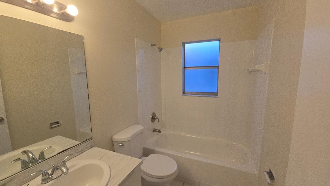 4403 Treehouse Lane, Unit H Tamarac, FL 33319 - Photo 12 of 26 a bathroom with a toilet sink and bathtub