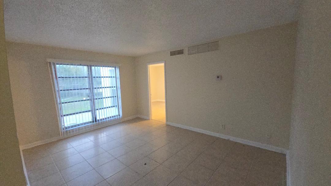 4403 Treehouse Lane, Unit H Tamarac, FL 33319 - Photo 13 of 26 an empty room with windows