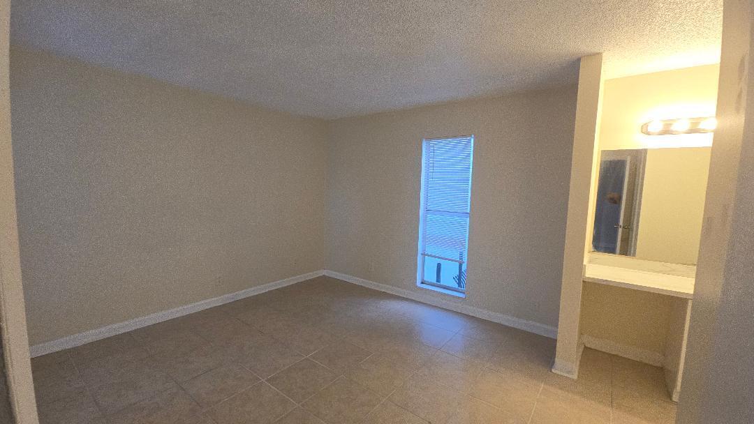 4403 Treehouse Lane, Unit H Tamarac, FL 33319 - Photo 14 of 26 an empty room with windows