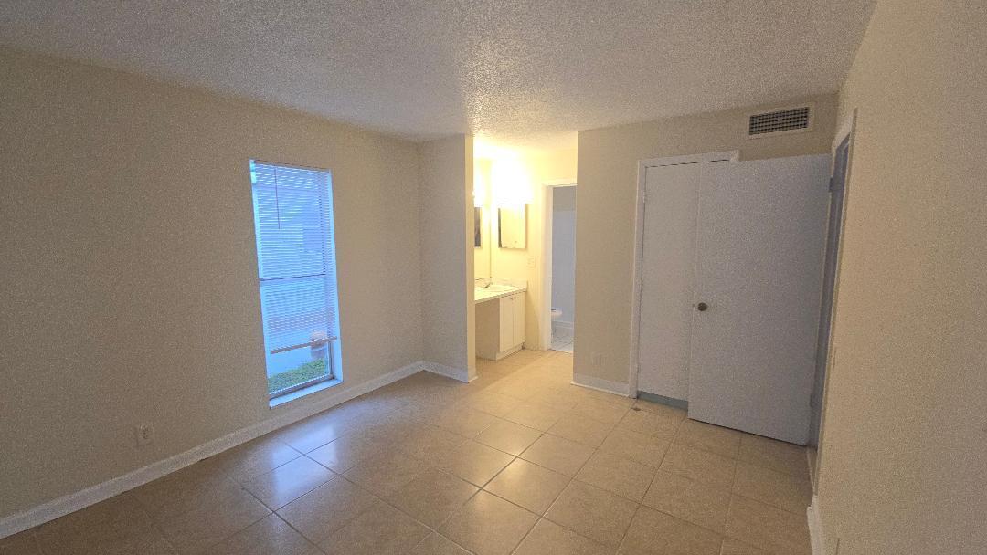 4403 Treehouse Lane, Unit H Tamarac, FL 33319 - Photo 15 of 26 a view of an empty room with window