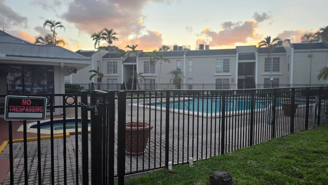 4403 Treehouse Lane, Unit H Tamarac, FL 33319 - Photo 24 of 26 a view of a brick building from a balcony