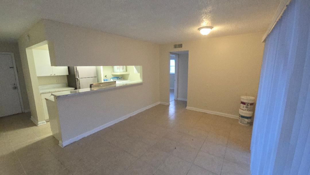4403 Treehouse Lane, Unit H Tamarac, FL 33319 - Photo 7 of 26 a view of a kitchen cabinets and a wooden floor