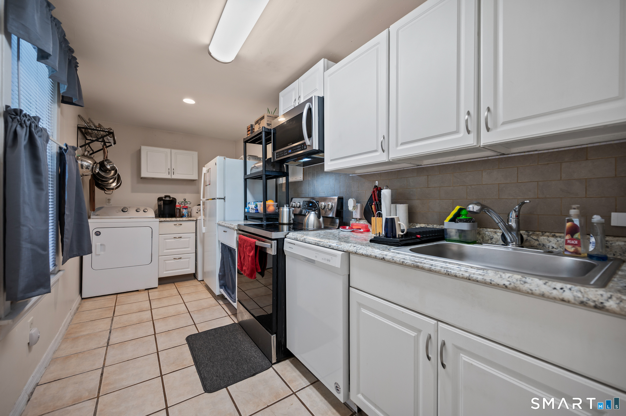 3 Flower Street Middletown, CT 06457 - Photo 7 of 17 a kitchen with a sink dishwasher refrigerator and cabinets