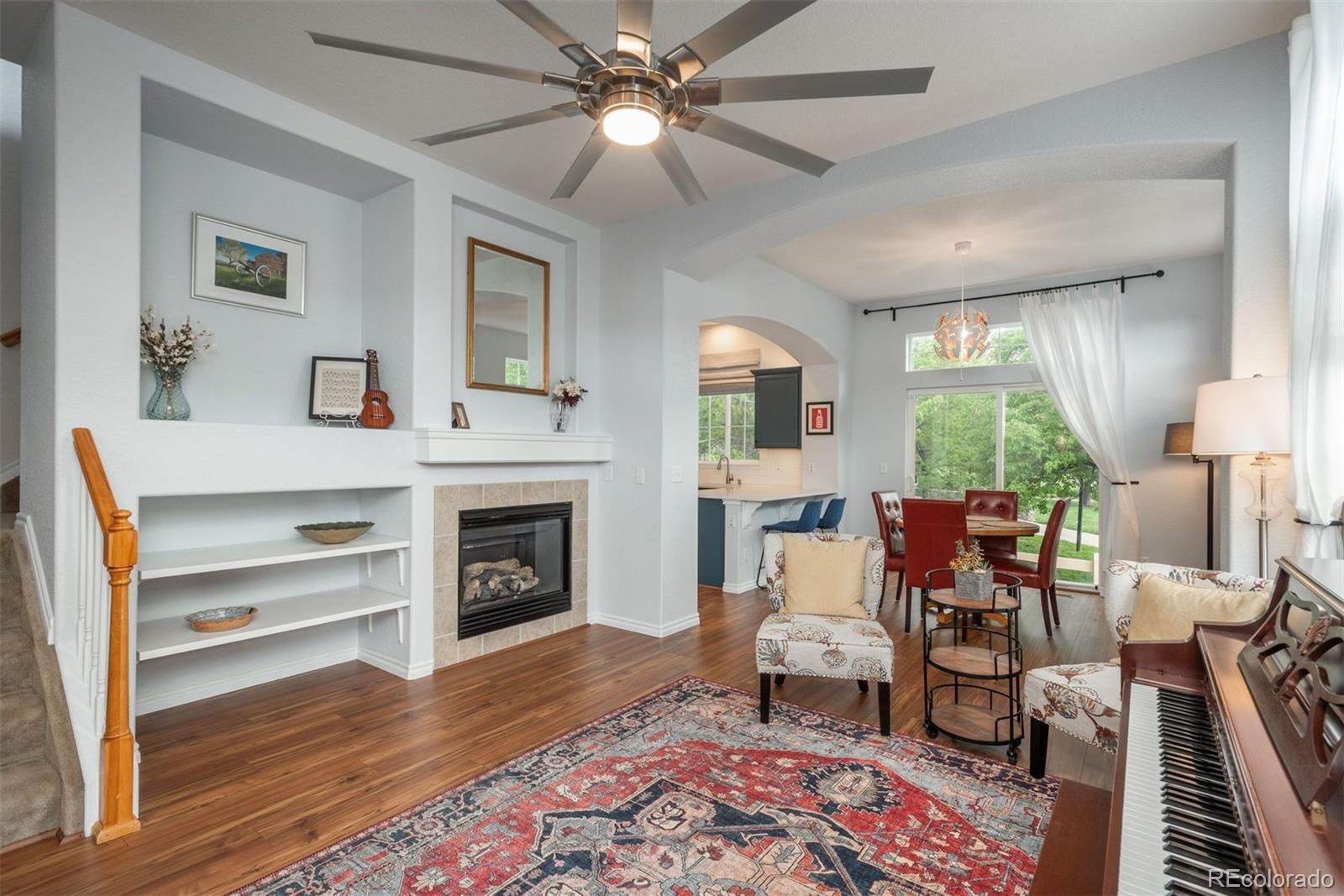 a living room with furniture and a fireplace