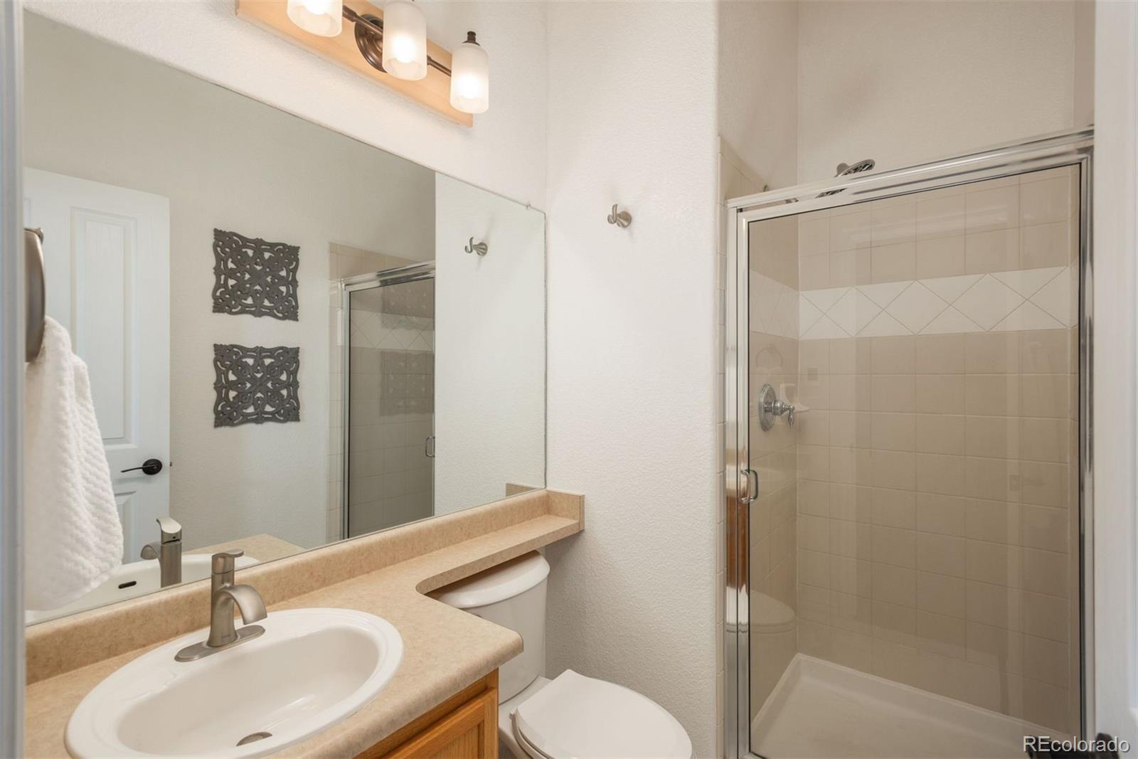 10696 Riverbrook Circle Highlands Ranch, CO 80126 - Photo 11 of 24 a bathroom with a sink toilet and shower