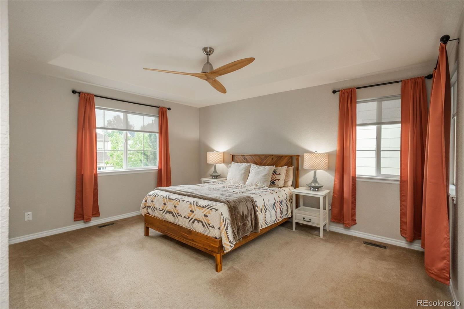 10696 Riverbrook Circle Highlands Ranch, CO 80126 - Photo 12 of 24 a bed sitting in a bedroom next to a window
