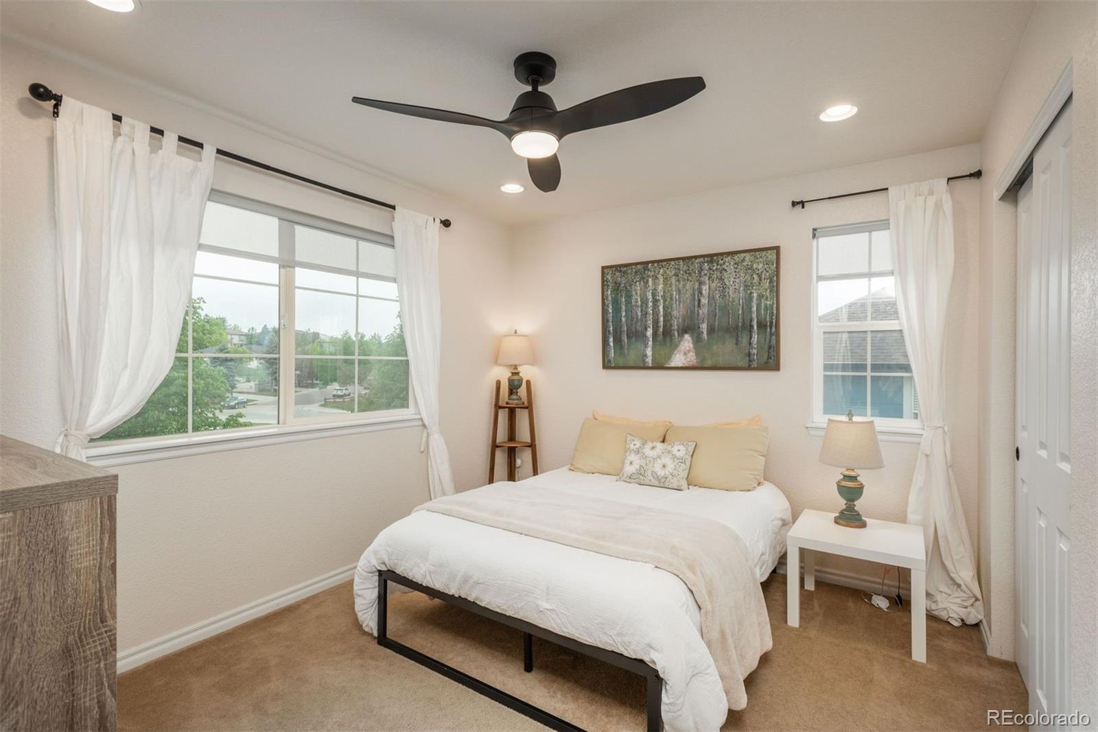 10696 Riverbrook Circle Highlands Ranch, CO 80126 - Photo 16 of 24 a bedroom with a large bed and a window