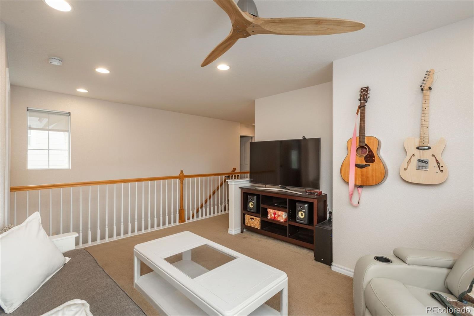 10696 Riverbrook Circle Highlands Ranch, CO 80126 - Photo 19 of 24 a living room with furniture and a flat screen tv
