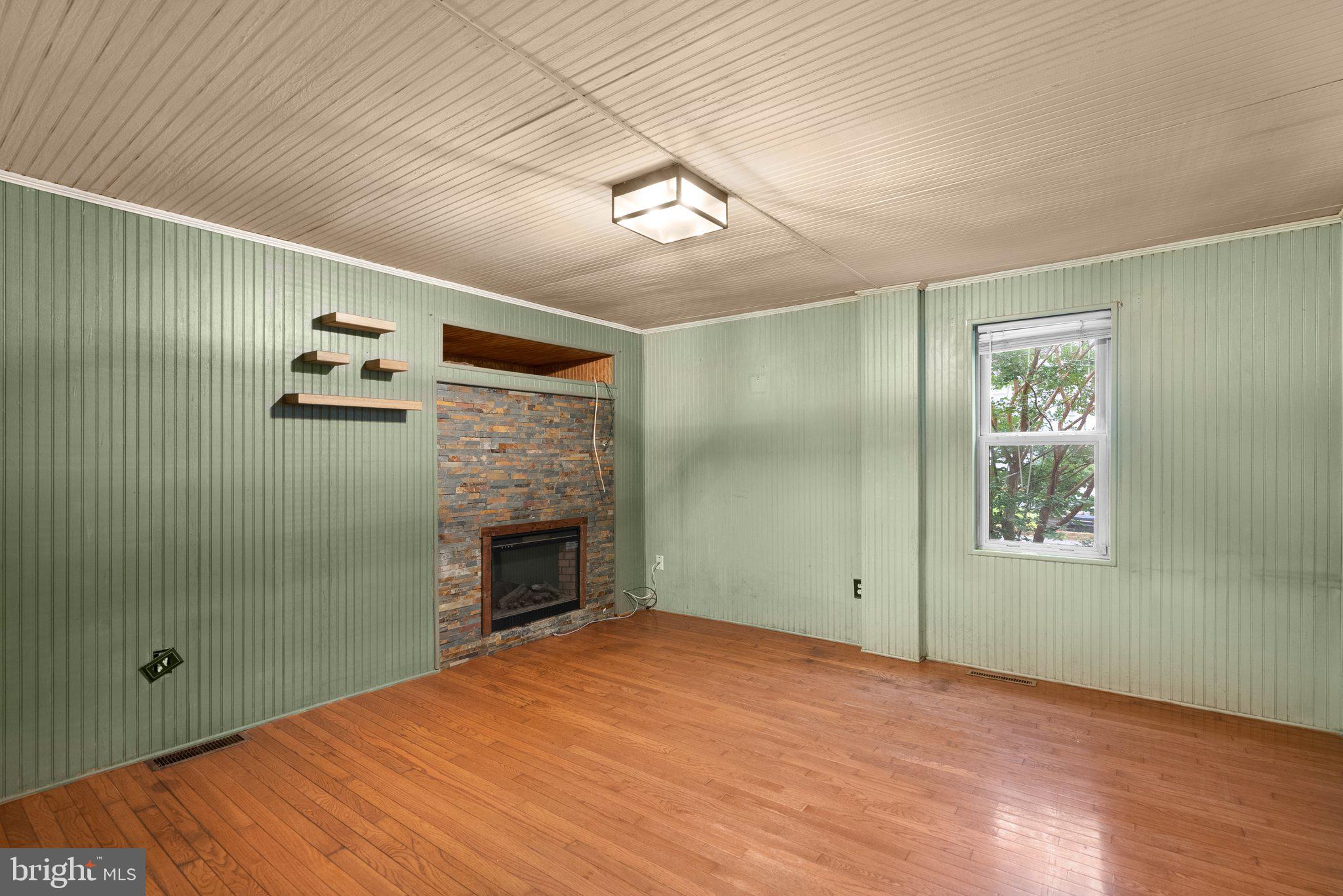 810 Knoxville Road Knoxville, MD 21758 - Photo 12 of 42 a view of empty room with window and fireplace