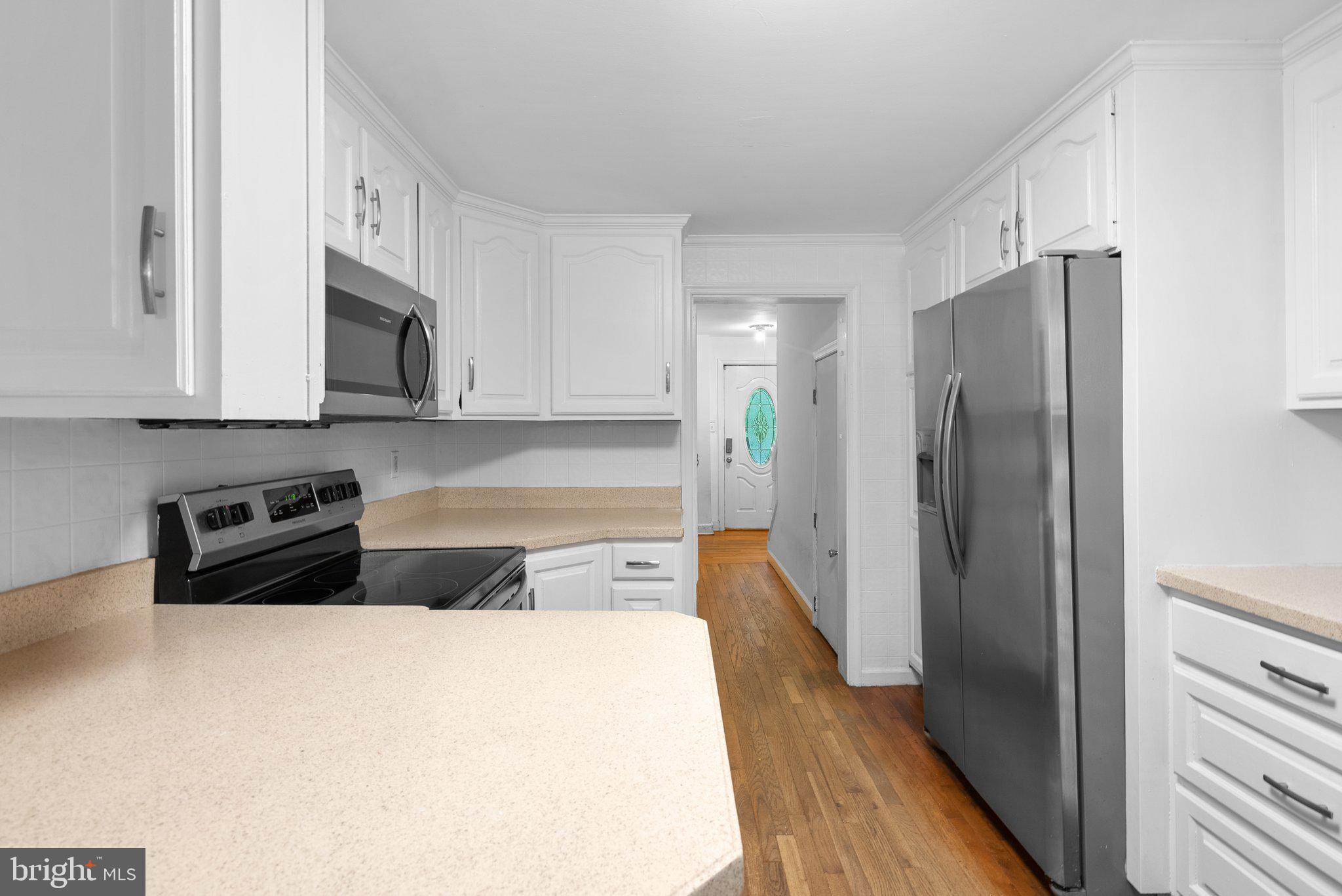 810 Knoxville Road Knoxville, MD 21758 - Photo 17 of 42 a kitchen with stainless steel appliances a refrigerator a stove and white cabinets