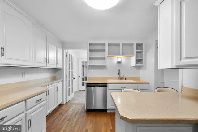 a kitchen with granite countertop white cabinets and white appliances