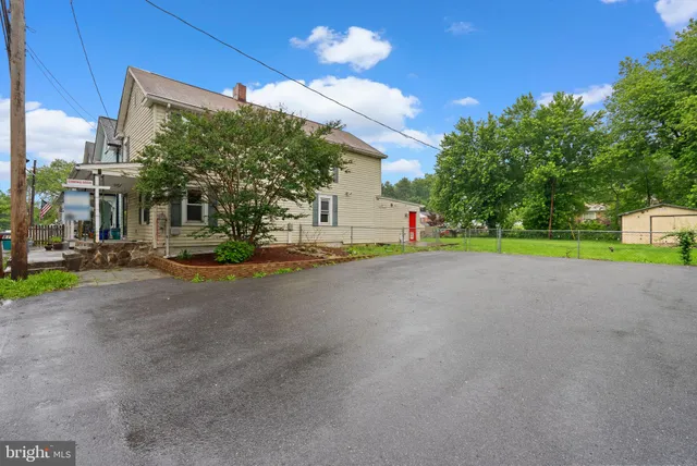 a view of a house with entertaining space and a street view