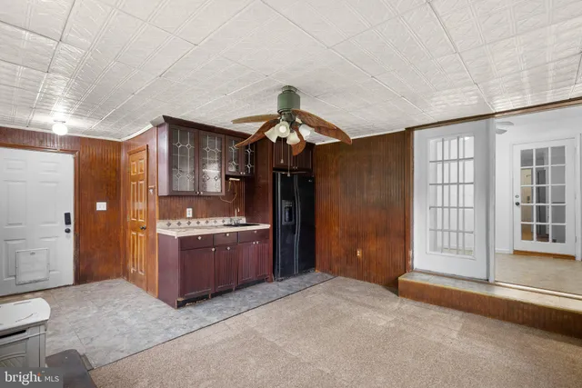 a kitchen with kitchen island granite countertop wooden cabinets and stainless steel appliances