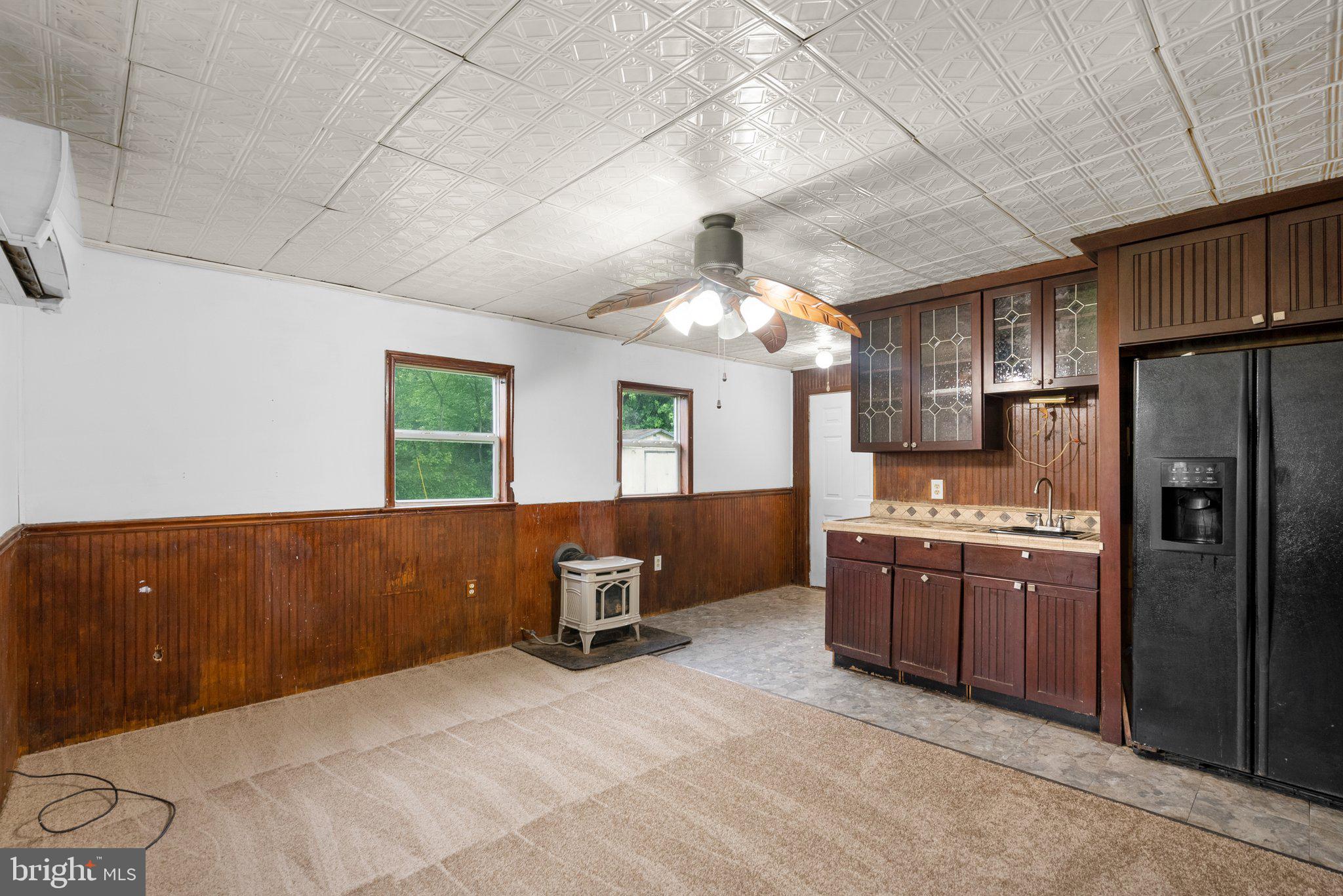 810 Knoxville Road Knoxville, MD 21758 - Photo 28 of 42 a kitchen with stainless steel appliances kitchen island granite countertop a refrigerator and a stove top oven