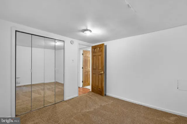 an empty room with closet area
