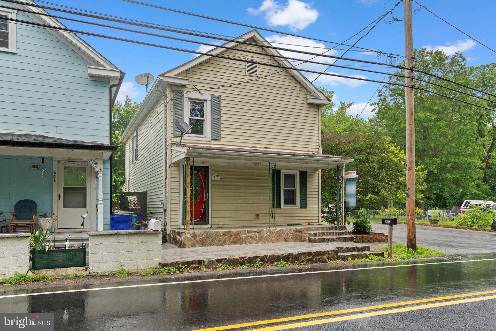 810 Knoxville Road Knoxville, MD 21758 - Photo 4 of 42 a view of a white house with large windows and a table