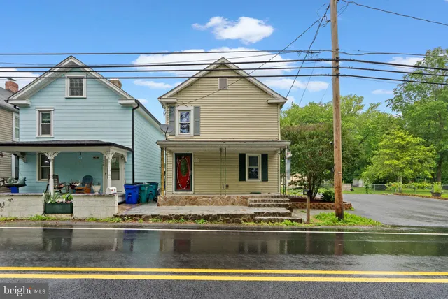a view of house with swimming pool and outdoor seating