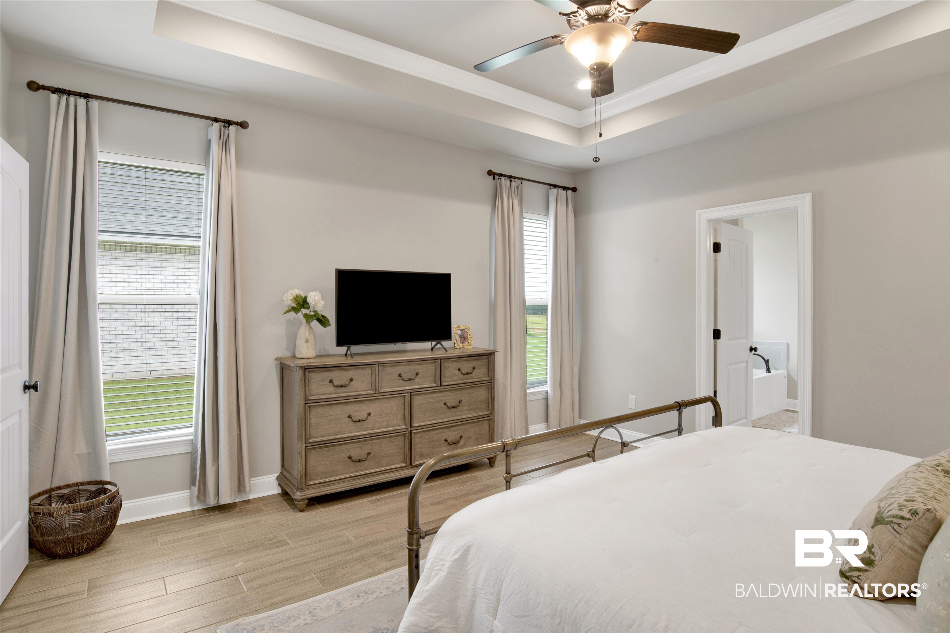 30770 Marcel Boulevard Spanish Fort, AL 36527 - Photo 14 of 23 Bedroom featuring light hardwood / wood-style flooring, ceiling fan, and a tray ceiling