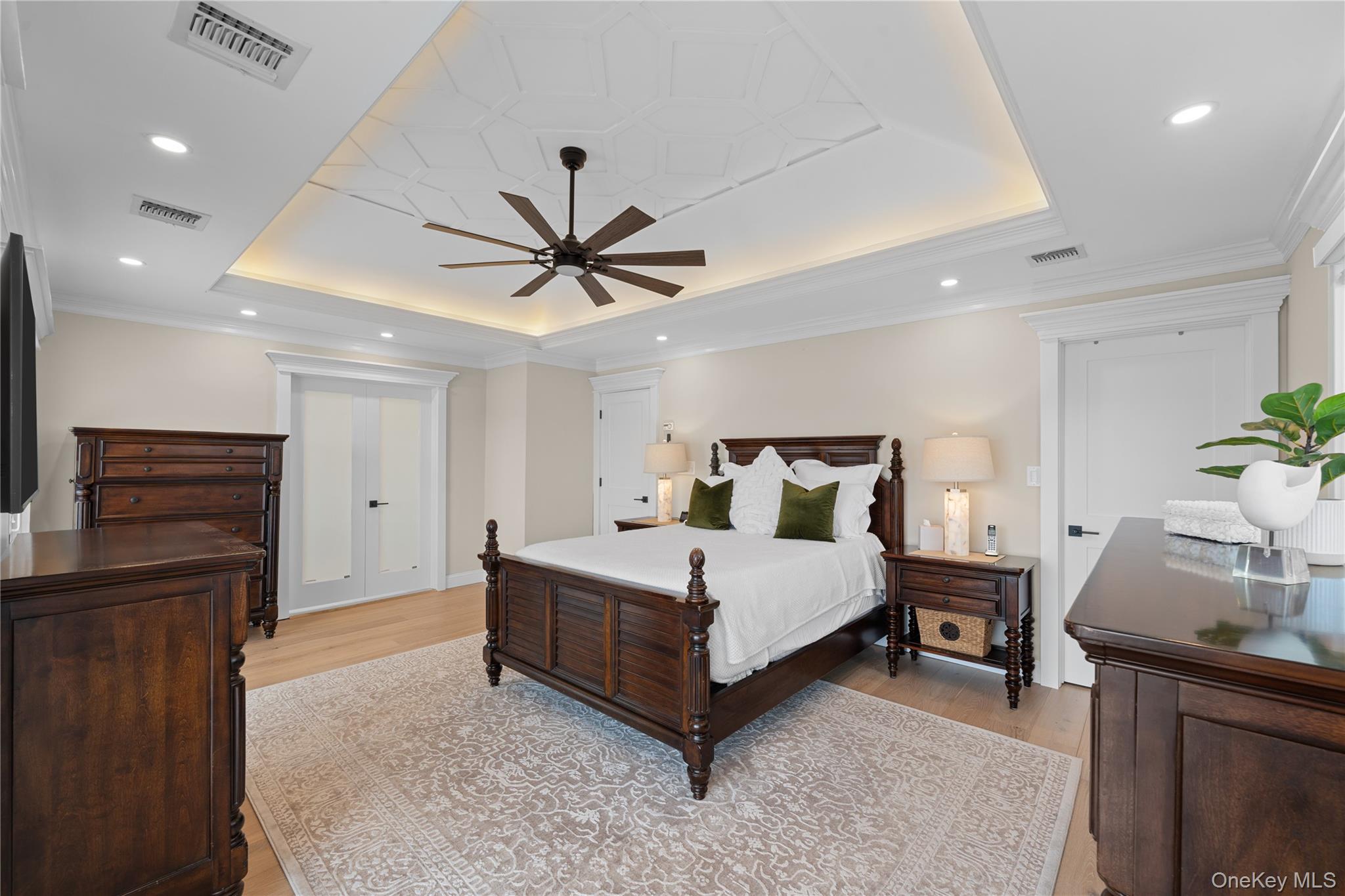 29 Dyke Road Setauket, NY 11733 - Photo 11 of 44 a spacious bedroom with a bed and a chandelier