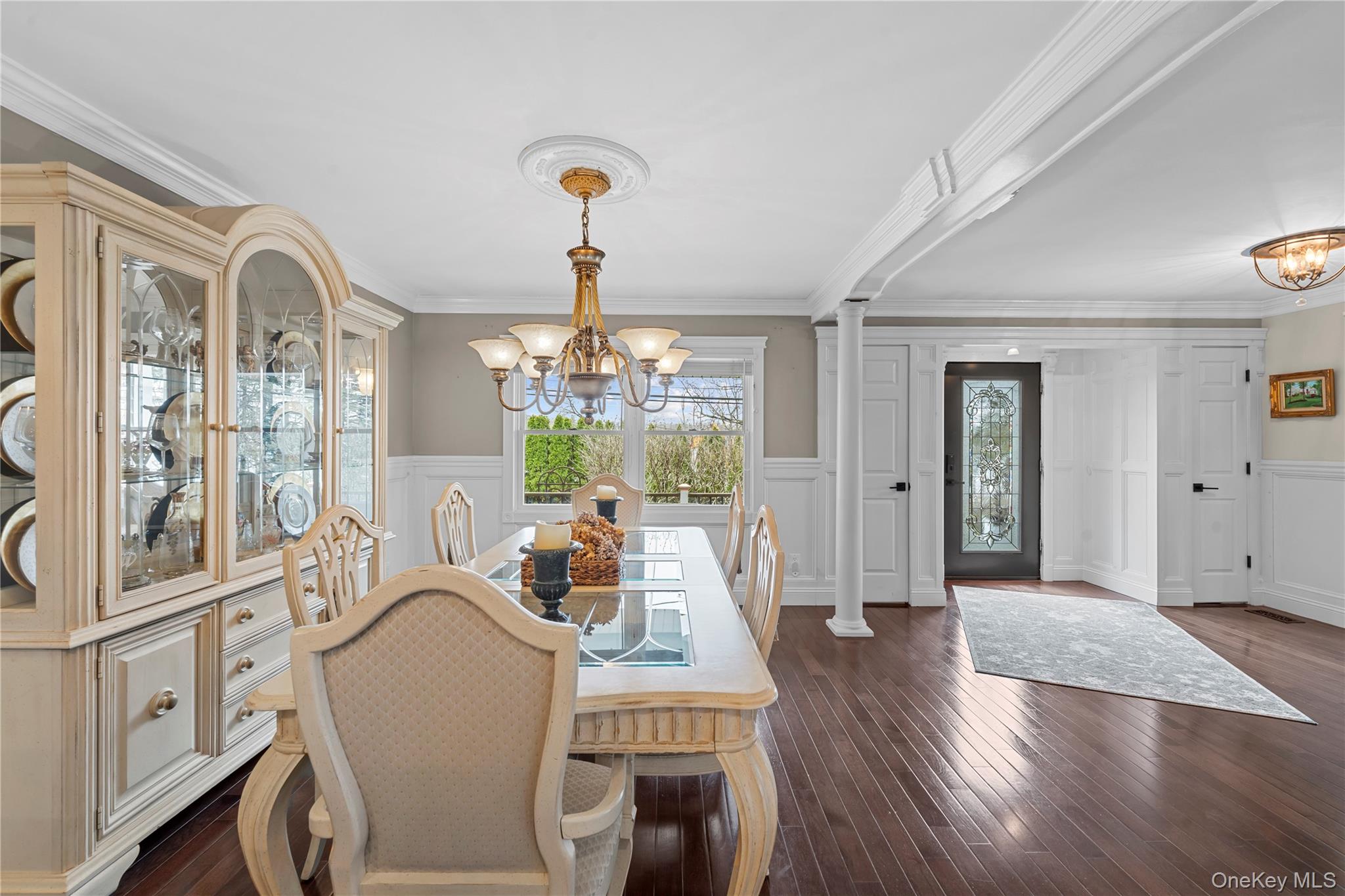 29 Dyke Road Setauket, NY 11733 - Photo 22 of 44 a view of a dining room with furniture a chandelier and wooden floor